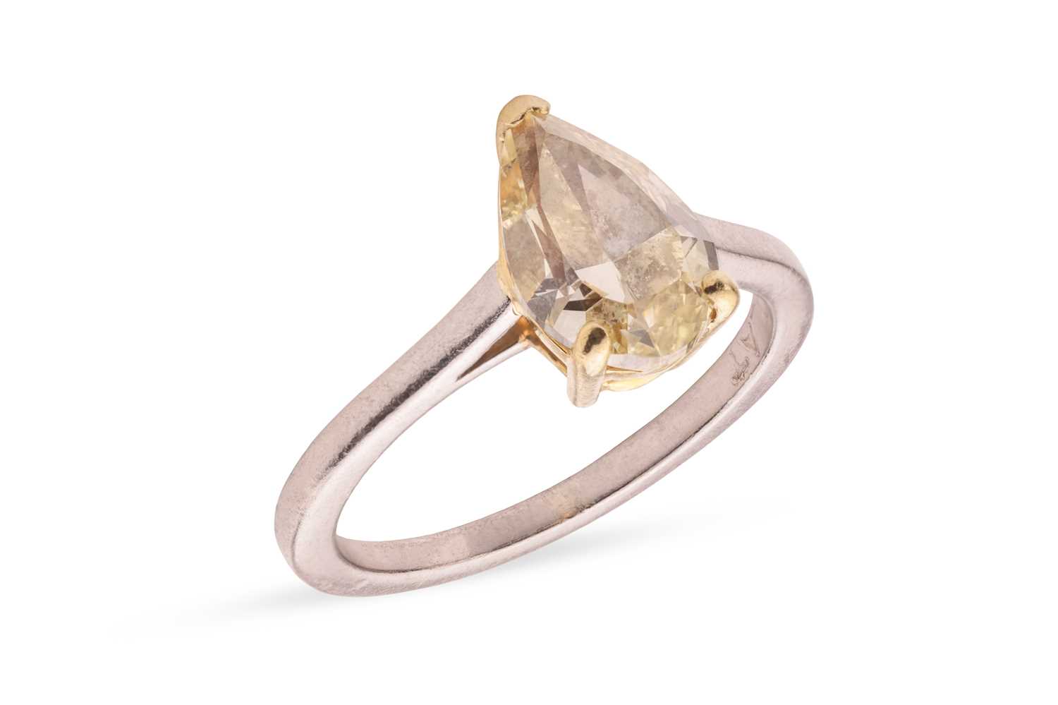 Lot A pear-cut fancy yellow diamond solitaire ring,...