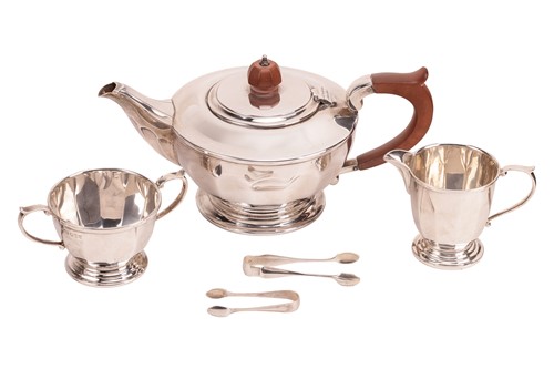 Lot 428 - A three-piece silver tea set, of panelled...