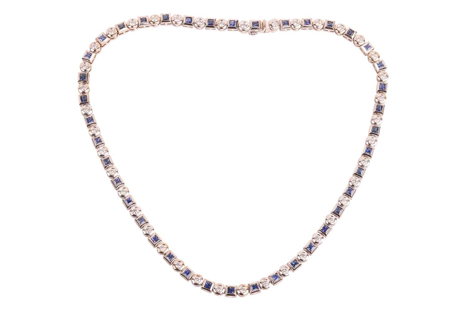 Lot A diamond and sapphire riviere necklace in...