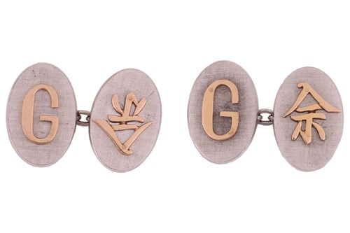 Lot 82 - A pair of two-tone cufflinks with applied...