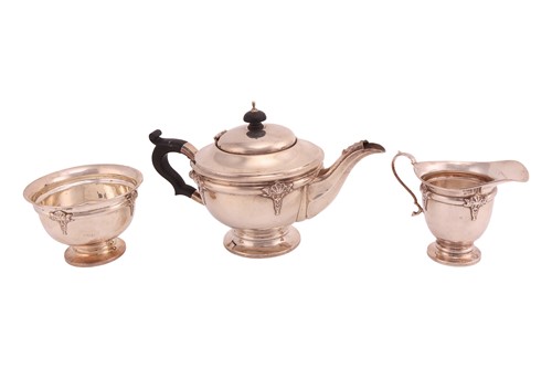 Lot 421 - A silver three-piece tea set, circular with...