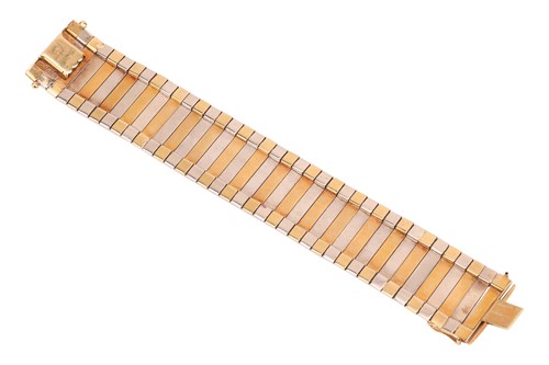 Lot 35 - A two-tone omega chain bracelet with a pair of...