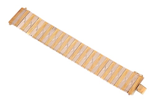 Lot 35 - A two-tone omega chain bracelet with a pair of...