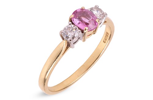 Lot 324 - A pink sapphire and diamond trilogy ring in...