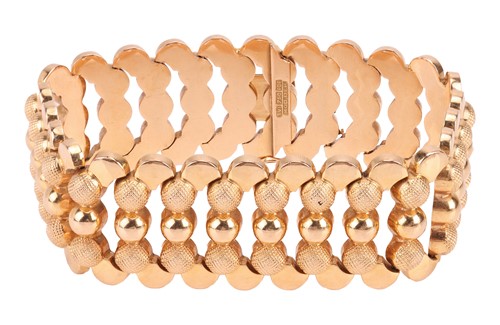 Lot A wide articulated bracelet, comprising a...