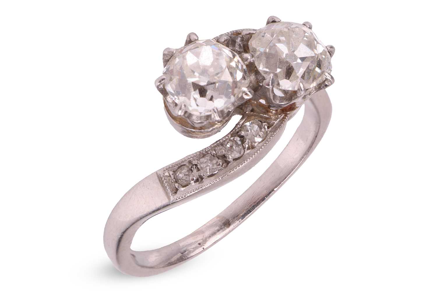 Lot A diamond-set crossover ring, claw-set with...