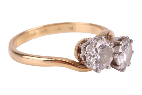Lot A diamond-set crossover ring, claw-set with...