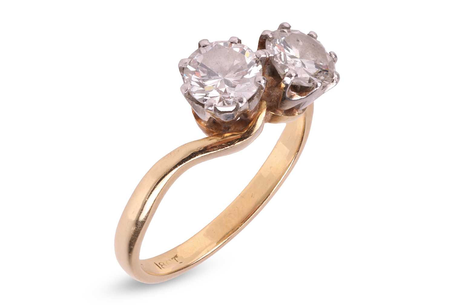 Lot A diamond-set crossover ring, claw-set with...