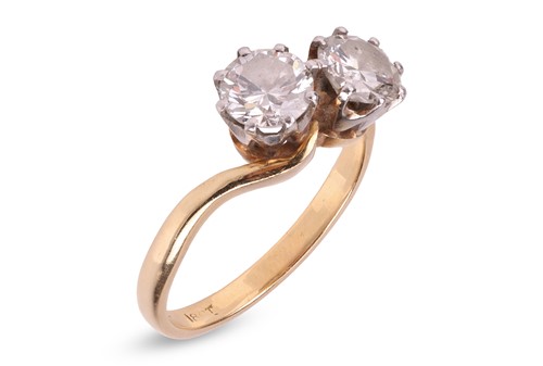 Lot A diamond-set crossover ring, claw-set with...