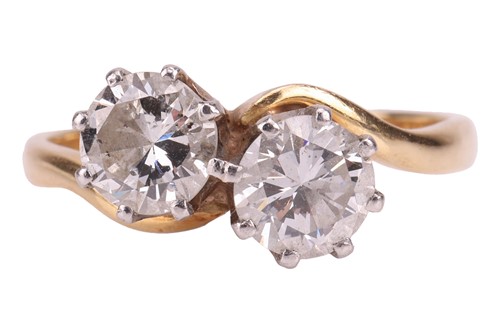 Lot A diamond-set crossover ring, claw-set with...
