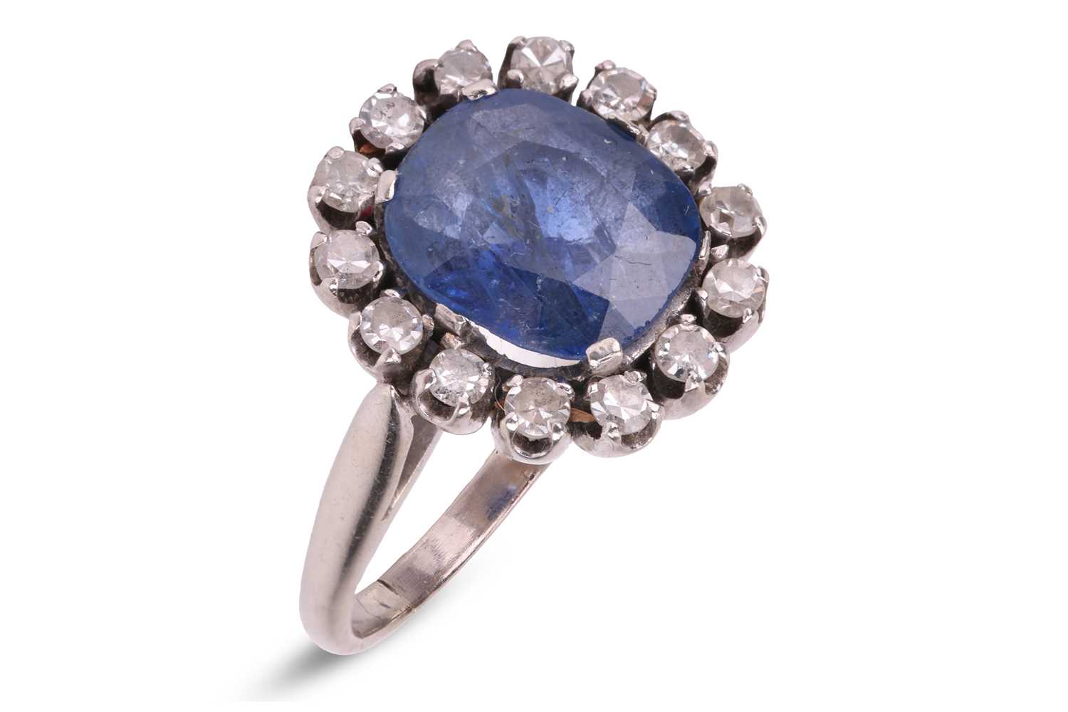 Lot A sapphire and diamond cluster ring, centred...