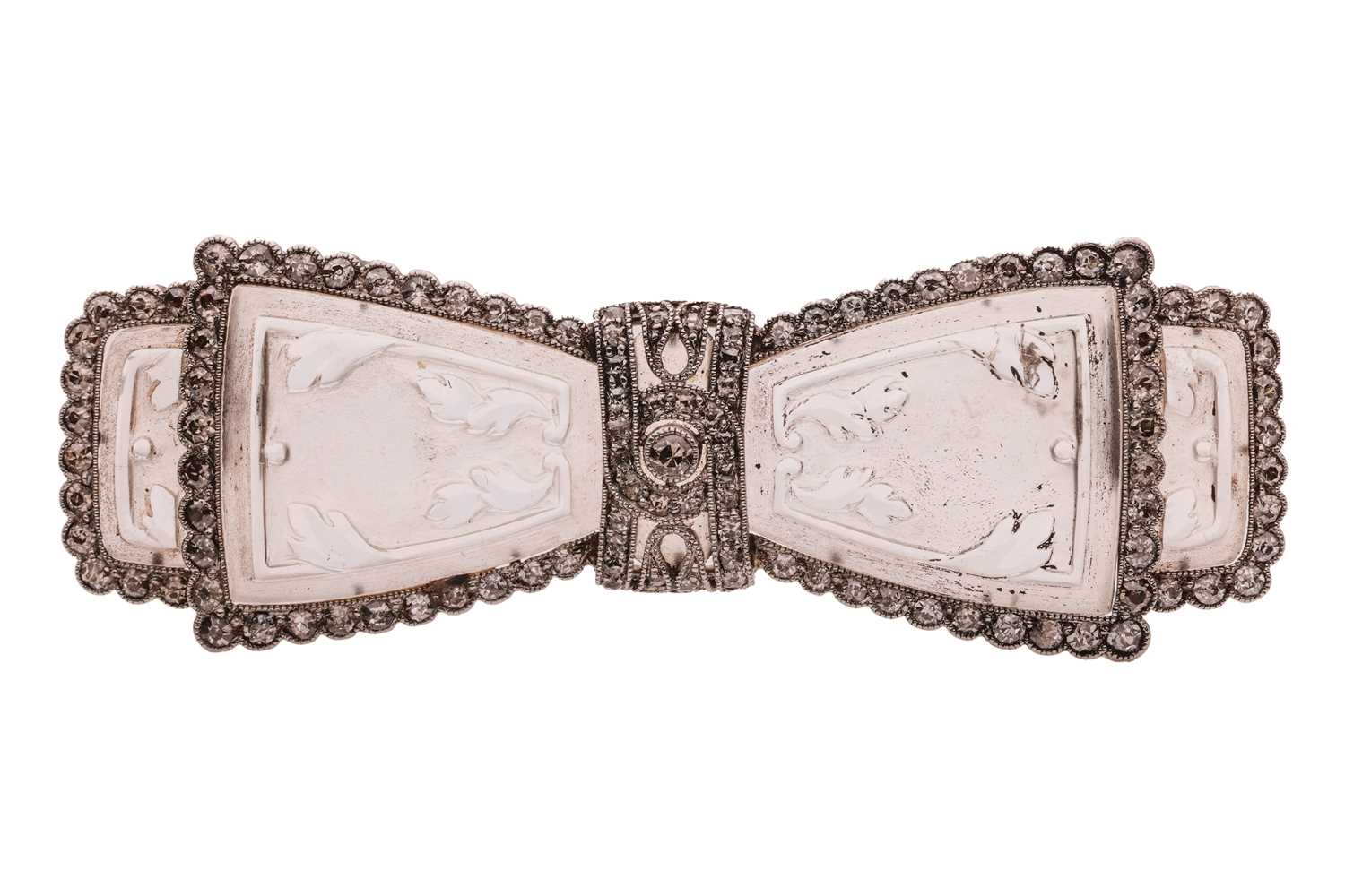 Lot 207 - A carved rock crystal and diamond-set bow...