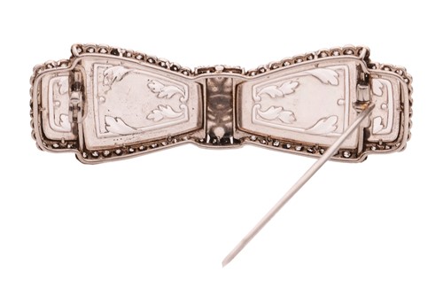 Lot 207 - A carved rock crystal and diamond-set bow...