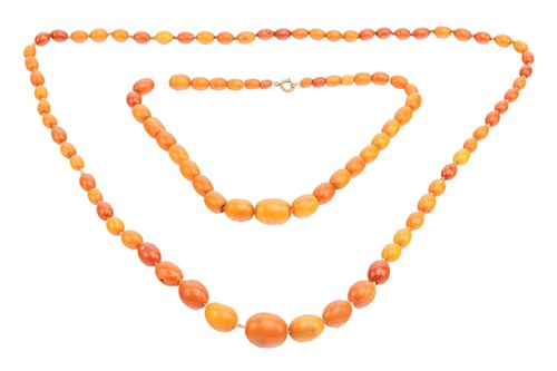 Lot 136 - Two necklaces of butterscotch amber beads; the...