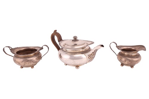 Lot 449 - A three-piece silver teaset, circular with...