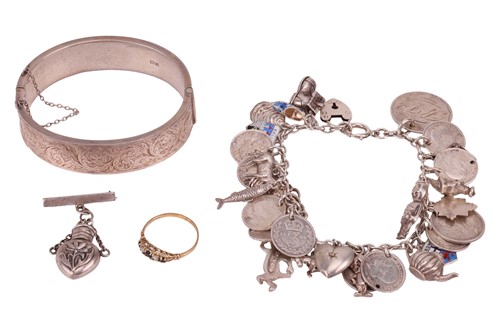 Lot 71 - A charm bracelet, with silver and white metal...