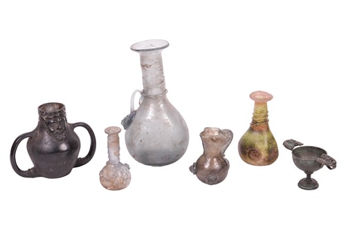 Lot 282 - Four items of Roman glass, to include a tall...