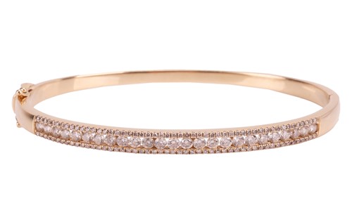 Lot 255 - A diamond-set hinged bangle, comprising a...