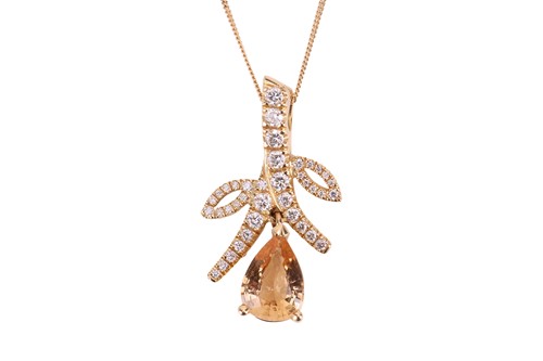 Lot 47 - A yellow topaz and diamond pendant on chain,...