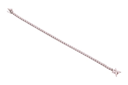 Lot 128 - A diamond-set line bracelet, claw-set with...
