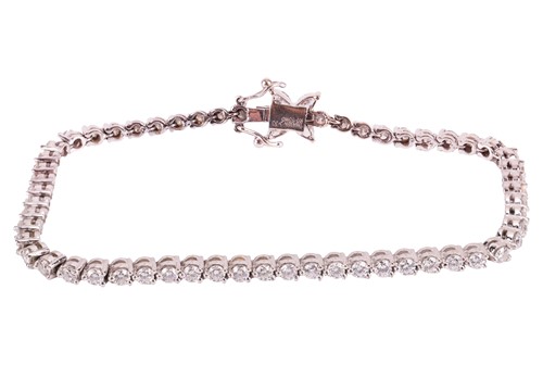 Lot 128 - A diamond-set line bracelet, claw-set with...