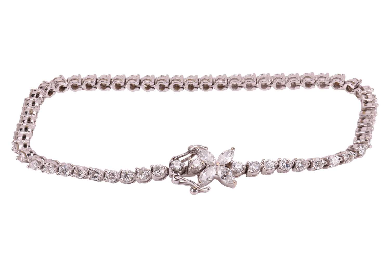 Lot 128 - A diamond-set line bracelet, claw-set with...