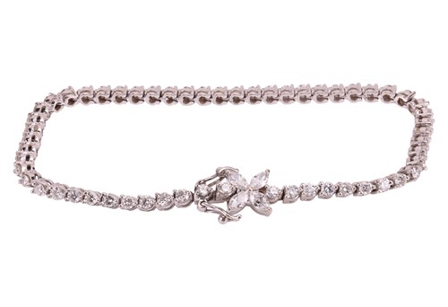 Lot 128 - A diamond-set line bracelet, claw-set with...