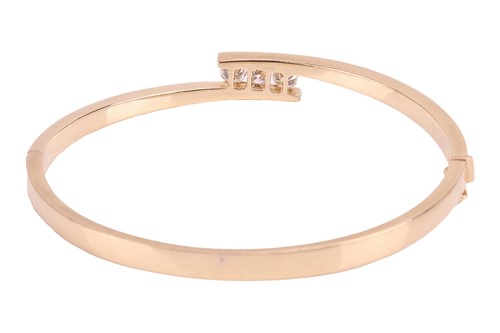 Lot 74 - A diamond-set hinged bangle, of crossover...