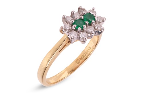 Lot 296 - An emerald and diamond cluster ring in 18ct...