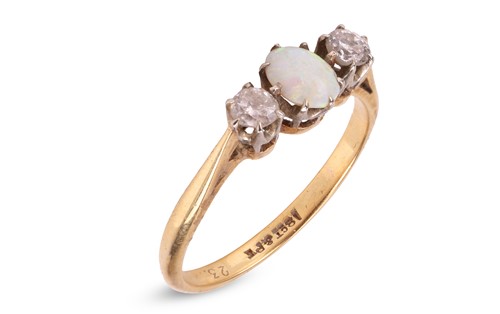 Lot 246 - An opal and diamond-set ring, the central opal...
