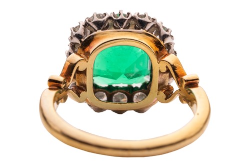 Lot 82 - A Colombian emerald and diamond cluster ring,...