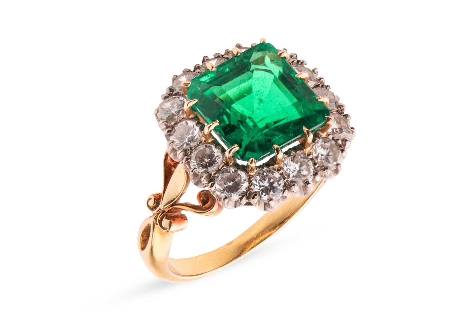 Lot 82 - A Colombian emerald and diamond cluster ring,...