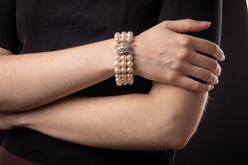 Lot 79 - A cultured pearl bracelet with diamond-set...