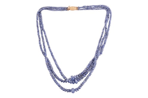 Lot 43 - A three-strand sapphire bead necklace,...