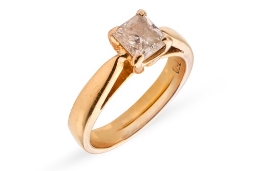 Lot A diamond solitaire ring, featuring a central...