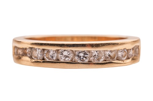 Lot A diamond half-eternity ring, featuring a...