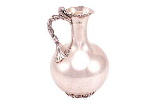 Lot 365 - A late Victorian silver ewer, the bulbous body...