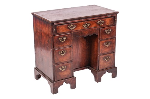 Lot A George II walnut and mahogany kneehole desk,...