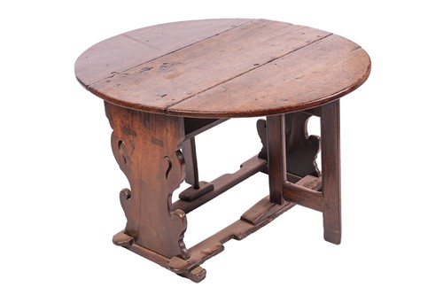 Lot 56 - An oak vernacular drop leaf table, the oval...