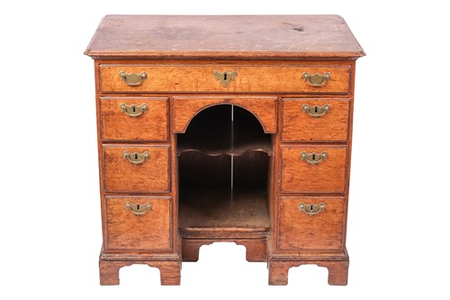 Lot 41 - A George III oak kneehole desk, the top with...