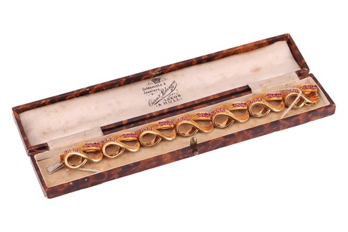 Lot An Italian ruby-set lemniscate link bracelet,...