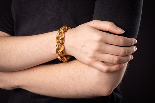 Lot An Italian ruby-set lemniscate link bracelet,...