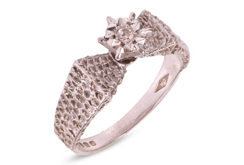 Lot 58 - A single stone illusion-set diamond ring, set...