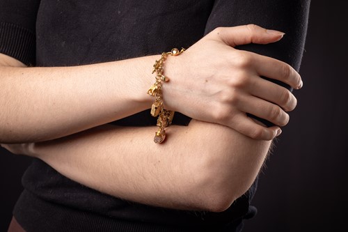 Lot A charm bracelet, comprising a series of...