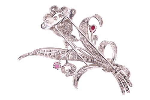 Lot A floral spray brooch set with diamond and...