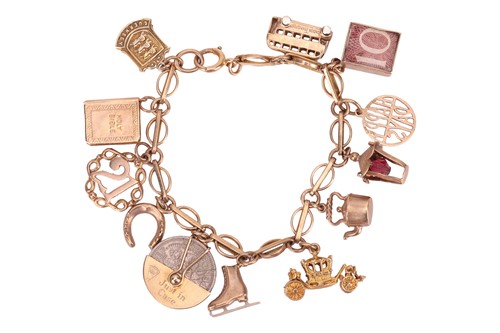 Lot 101 - A charm bracelet, with twelve charms, the...