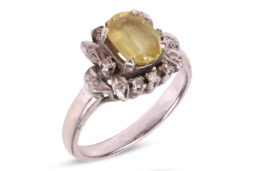 Lot 65 - A yellow sapphire and diamond cluster ring,...