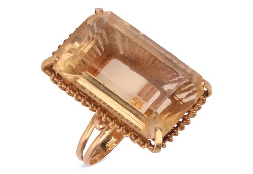 Lot A large citrine ring, featuring a large...