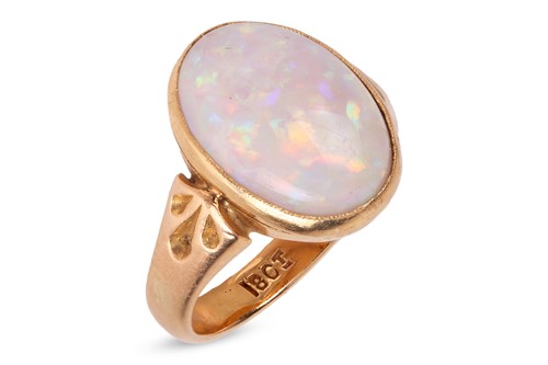 Lot An opal dress ring, the oval precious opal...