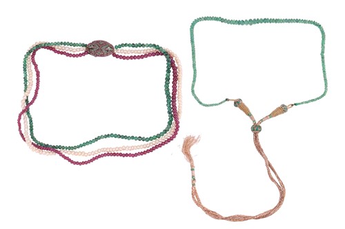 Lot 213 - A three-strand bead necklace and an emerald...